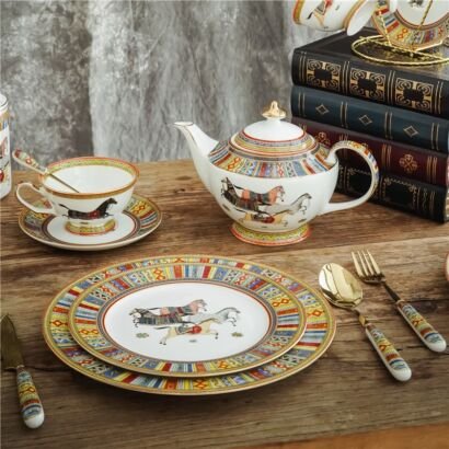 Luxury bone china tea and dinnerware set featuring galloping horses and colorful geometric borders, including a teapot, teacup, saucer, stacked plates, and gold cutlery on a wooden table