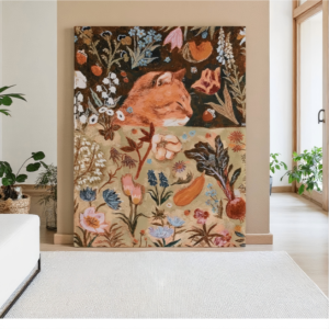 Large canvas wall art displaying an orange ginger cat peeking out from a dense, folk-art-style garden filled with colorful flowers, vegetables, and botanical illustrations in a modern room setting