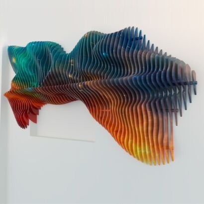A dynamic 3D layered parametric wall sculpture mounted on a plain white wall, constructed from multiple vertical acrylic panels featuring a gradient color transition from vibrant orange and red to deep teal and cobalt blue.