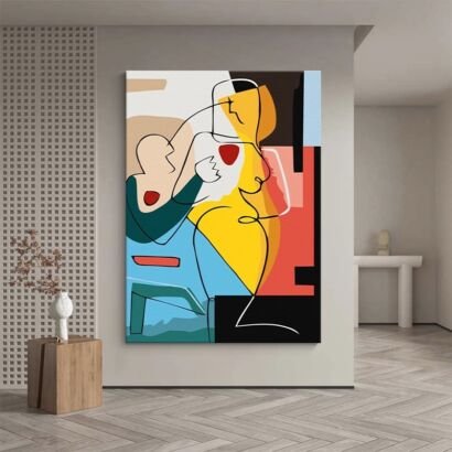 A large vertical abstract artwork on a light grey wall featuring bold continuous line drawings of stylized human figures superimposed over vivid color-blocked shapes in mustard yellow, sky blue, dark teal, coral red, beige, and black.