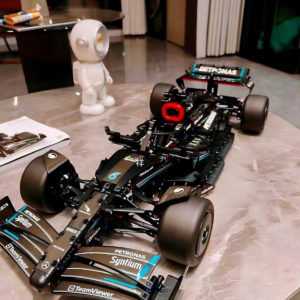 Mercedes-AMG Petronas F1 race car technical building block model, black teal Formula 1 brick vehicle displayed on marble round table