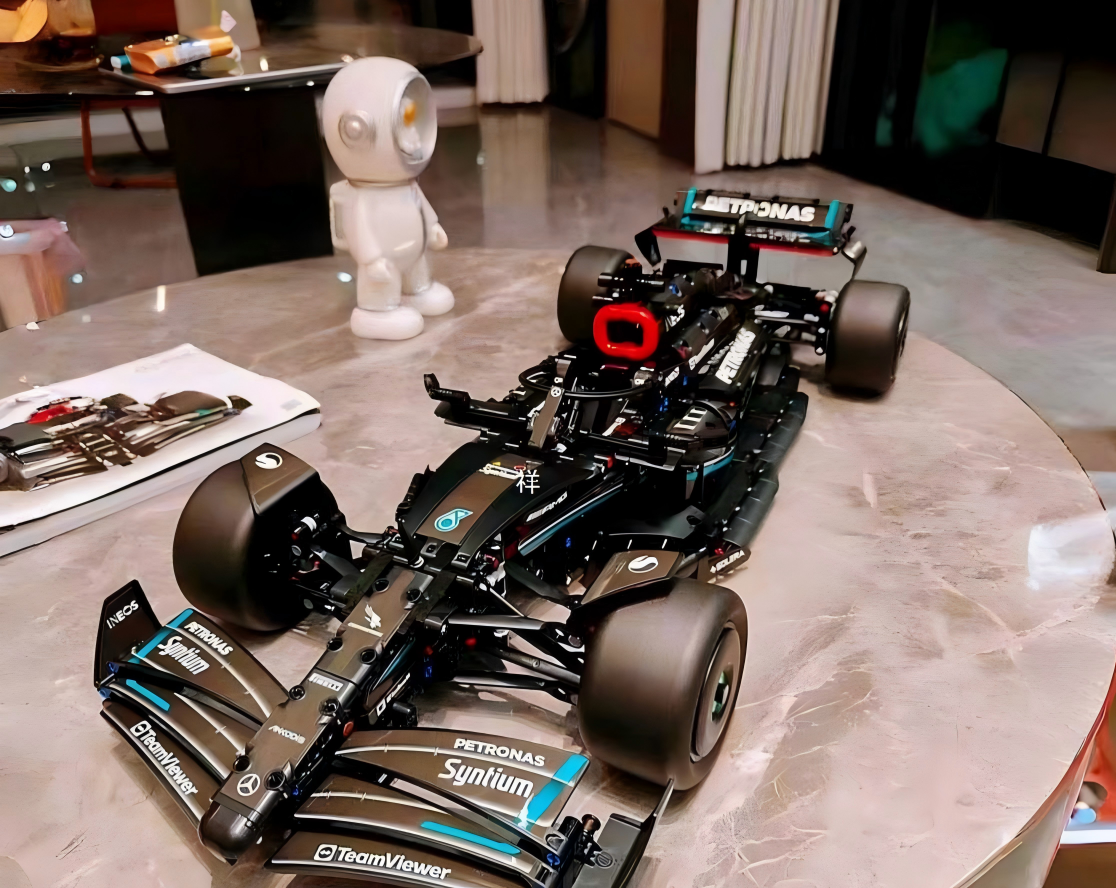 Mercedes-AMG Petronas F1 race car technical building block model, black teal Formula 1 brick vehicle displayed on marble round table