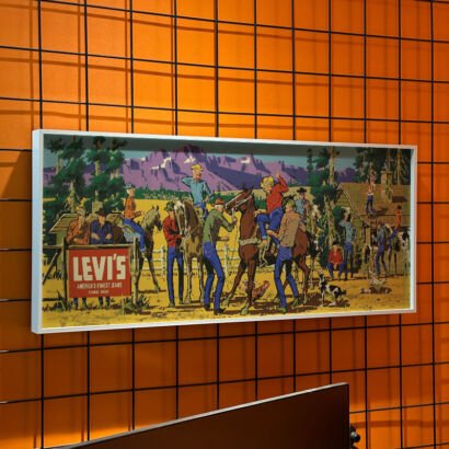 Vintage Levi's western cowboy illustration framed canvas wall art, retro ranch scene with cowboys, horses and mountain backdrop, hung on orange grid wall