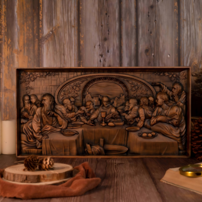 A horizontal rectangular wooden wall plaque featuring a detailed high-relief carving of The Last Supper with Jesus and His disciples gathered around a long table, enclosed within a wooden frame, displayed on a wooden surface next to pinecones and an old book.