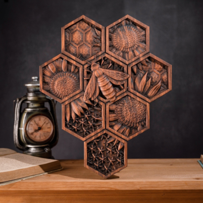 Ornately carved dark wood hexagon honeycomb sculpture featuring a 3D honeybee, sunflowers, and geometric cell patterns on a wooden table