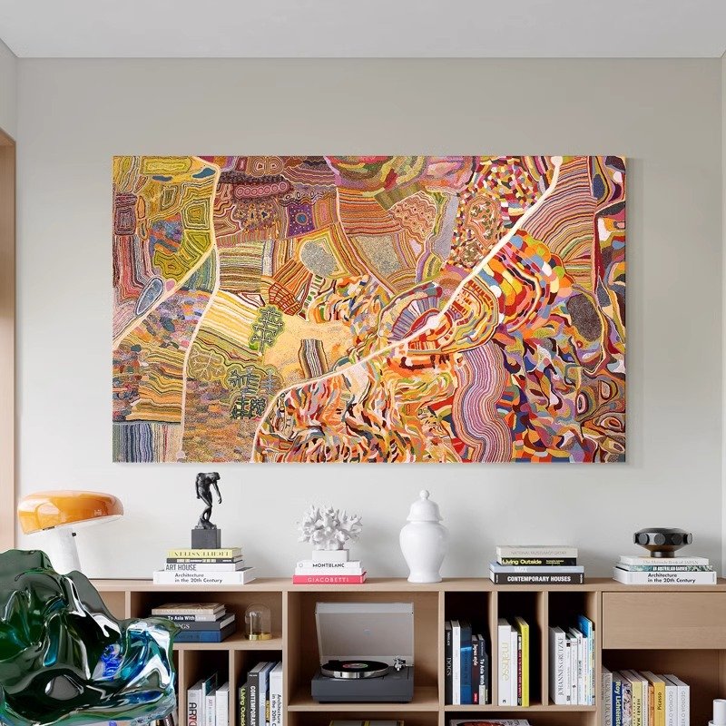 Horizontal aerial view abstract terrain canvas painting, colorful winding texture map-style wall art above wooden bookcase