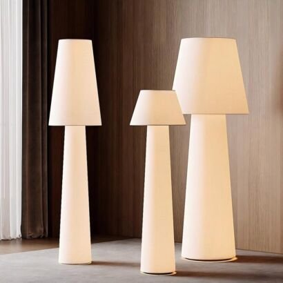 Three sizes minimalist white fabric floor lamps with tapered shapes displayed in modern interior