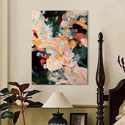 A vertical textured abstract canvas painting featuring expressive brushstrokes in peach, terracotta, warm orange, and deep forest green tones, hung above a lamp in a cozy bedroom setting.