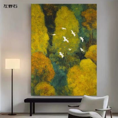 A large vertical canvas painting depicting white birds in flight above a vibrant golden and deep green forest canopy, displayed on a wall above a black bench in a modern room.