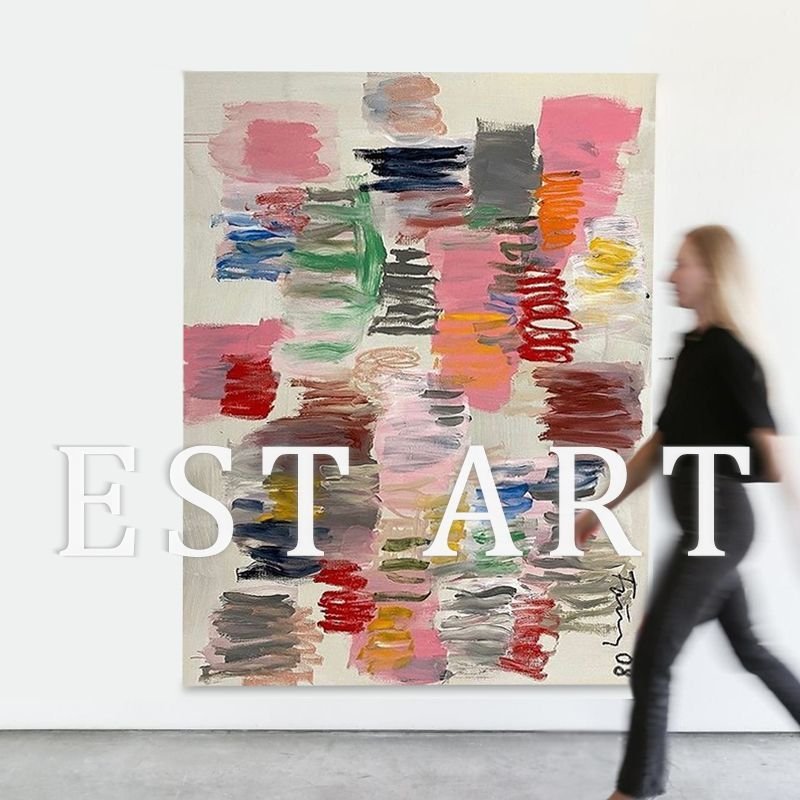 A large vertical abstract canvas painting featuring vibrant multicolor brushstrokes in pink, red, blue, green, and yellow displayed on a white wall.