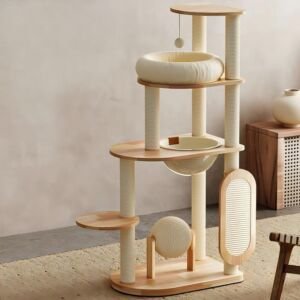 A modern light-wood multi-level cat tree featuring cream sisal-wrapped scratching posts, a round plush basket bed, a clear acrylic space capsule bowl, a top perching platform with a dangling ball toy, a spinning sisal ball, and an oval scratching pad attachment set in a stylish room.