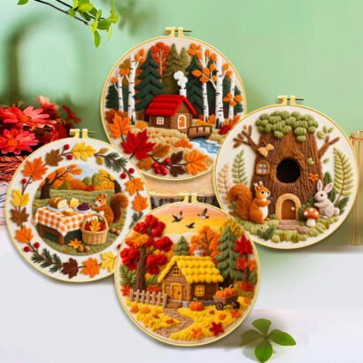 Four round embroidery hoops featuring rich 3D textured autumn embroidery scenes, including a cozy log cabin in an autumn pine forest, a squirrel enjoying a picnic spread surrounded by fall leaves, a cute treehouse home with a squirrel and rabbit, and a golden cottage with pumpkin cart accents against a light green background.