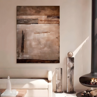 A vertical large abstract canvas wall art hanging on a warm beige wall above a white sofa in a modern minimalist living room, featuring layered textured blocks in earthy browns, taupe, cream, and charcoal.