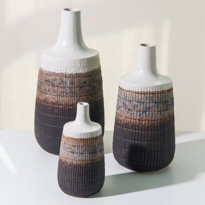 Set of three tall ceramic bottle vases with white glaze tops and dark textured brown gradient bases