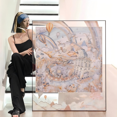 A large square transparent acrylic floating frame displaying a fine silk scarf with dreamy hot air balloon, architecture, and pastel fantasy illustrations, held next to indoor stairs.