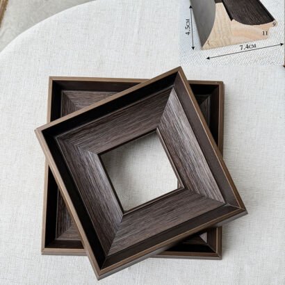 Dark brown wide bevel wooden picture frame blanks, square deep stepped wood moulding frames stacked on linen fabric with dimension diagram