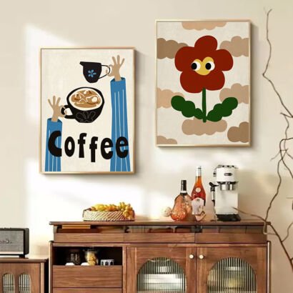 A set of two framed vertical wall art prints—one depicting illustrated hands holding coffee cups with the word "Coffee," and the other depicting a cute cartoon red flower with googly eyes—displayed above a wooden sideboard in a cozy room.