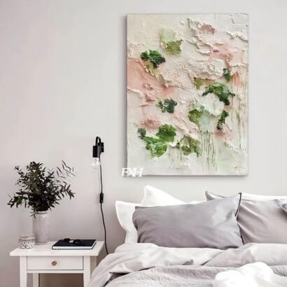 A vertical 3D textured abstract canvas painting featuring thick white, soft pink, and moss green impasto strokes hanging on a white wall above a bedroom headboard.