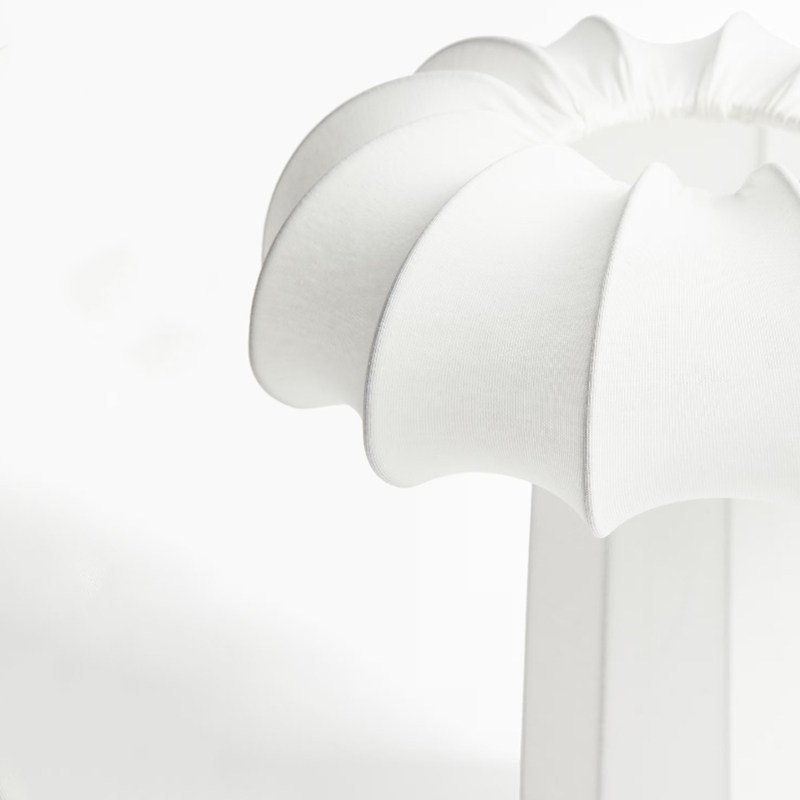 A uniquely distinctive small table lamp featuring white stretch fabric and a bulbous, garlic-like shape; suitable for living rooms, bedrooms, guesthouses, and hotels as a decorative interior lighting piece. - Image 5