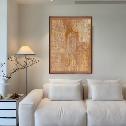 Large framed abstract canvas painting with warm beige, gold, and textured patchwork geometric patterns hanging above a white couch