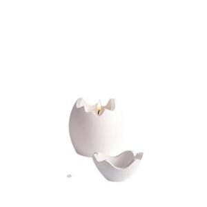 An isolated studio product shot of a two-piece matte white ceramic candle holder set shaped like a cracked eggshell, featuring a lit tealight flame inside the main vessel and a smaller matching wavy-edged dish in front against a clean white background.
