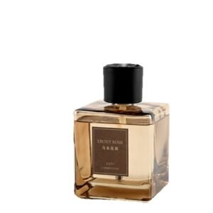 A heavy-bottomed square amber glass diffuser bottle with a minimalist brown label reading EBONY ROSE and a matte black cap.