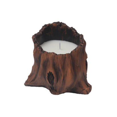 A white soy wax candle poured inside a realistic faux wood tree stump resin holder with detailed bark texture.