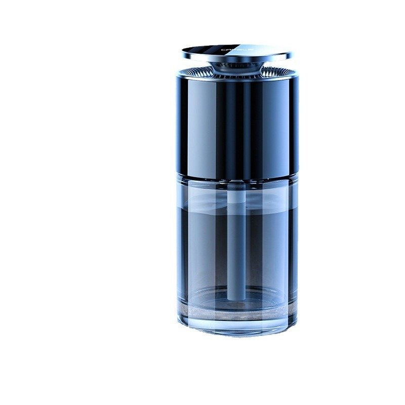 A modern black and clear glass cylindrical ultrasonic humidifier with a metallic top cap, designed for home office and bedroom desk use.