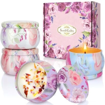 Scented candle gift set featuring portable floral tin containers, including one lit candle and one open candle embedded with colorful dried flower petals, displayed next to a floral gift box.