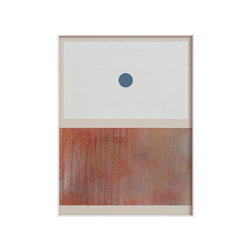 Framed minimalist abstract artwork split into a off-white upper section with a single blue circle and a textured terracotta rust-colored lower section