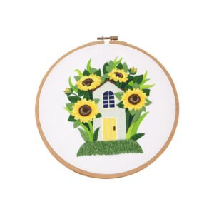 Embroidery hoop art featuring small house surrounded by sunflowers, handmade fabric wall decor