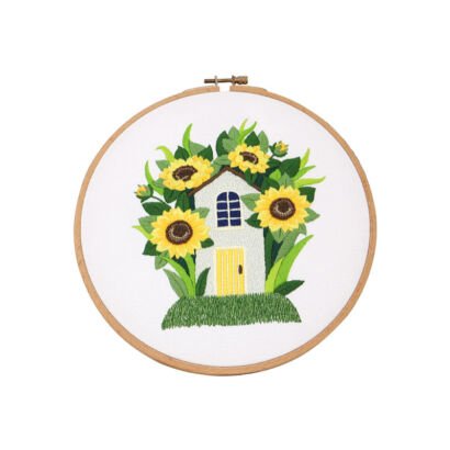 Embroidery hoop art featuring small house surrounded by sunflowers, handmade fabric wall decor