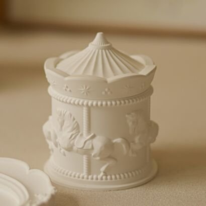 White plaster carousel-shaped candle jar with embossed horse relief, vintage merry-go-round aromatherapy candle container