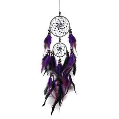 A detailed handmade dream catcher featuring two connected dark hoops with beaded webs and cascading vibrant purple and black feathers against a white background.