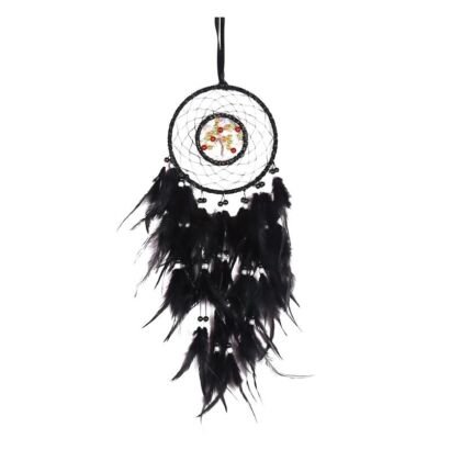 A detailed handmade black dream catcher with an intricate woven 'Tree of Life' center and a dense plume of black feathers, hanging against a white wall.