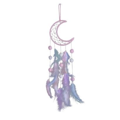 A detailed handmade dream catcher featuring a pink cord-wrapped crescent moon frame with beaded web, hanging pink and white pom poms, and soft pastel purple and blue feathers against a plain background.